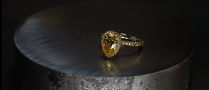 custom pear shaped yellow diamond engagement ring with french cut setting
